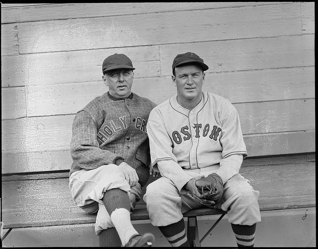 Babe Ruth in a baseball uniform shaking hands with a small boy — Calisphere