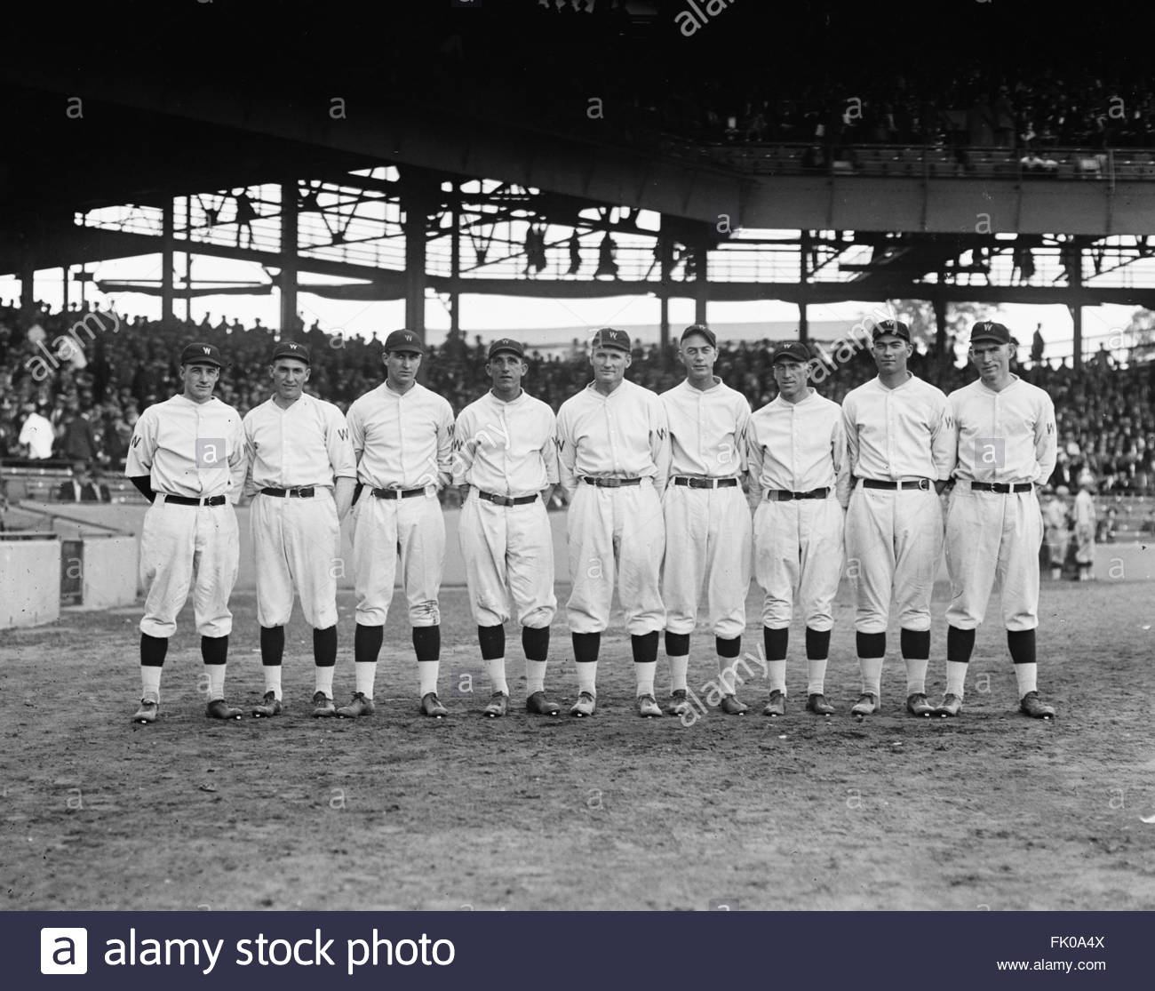 Babe Ruth in baseball uniform standing in dugout Stock Photo - Alamy