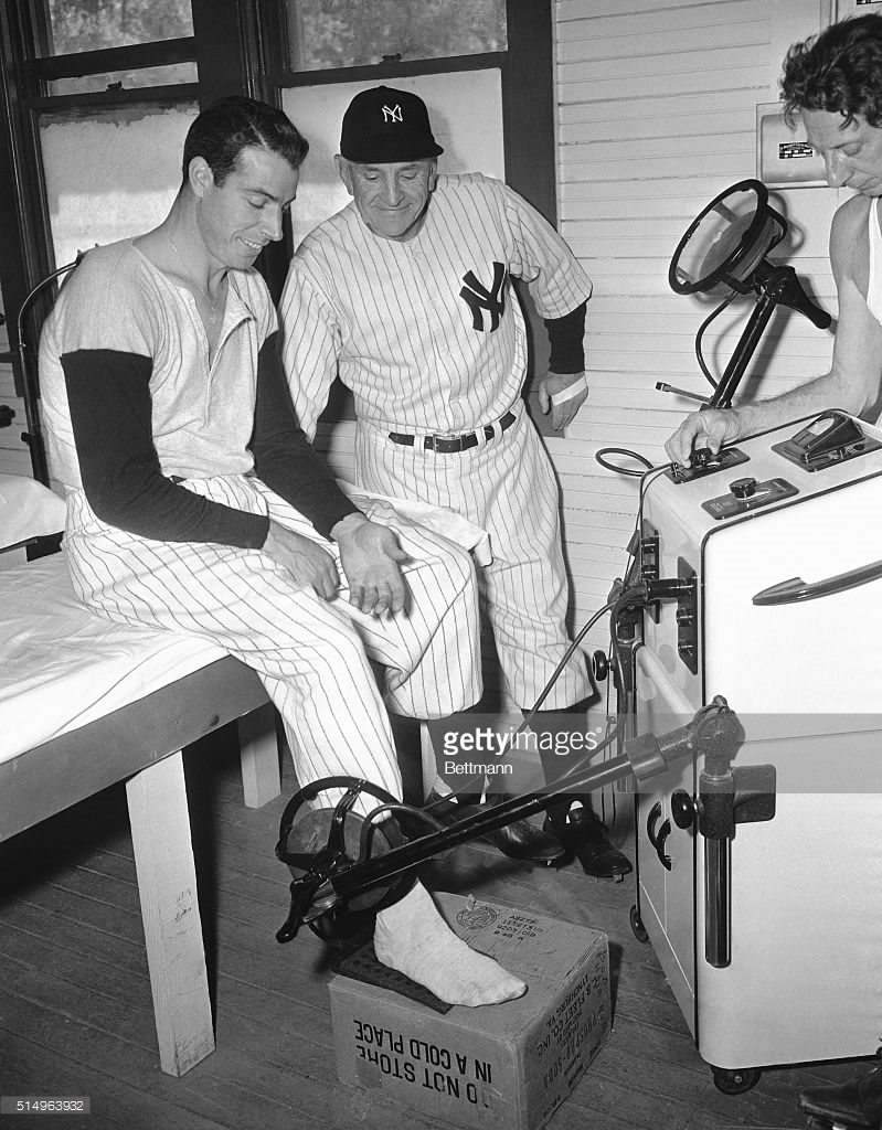 Joe Dimaggio And Mickey Mantle Holding by Bettmann