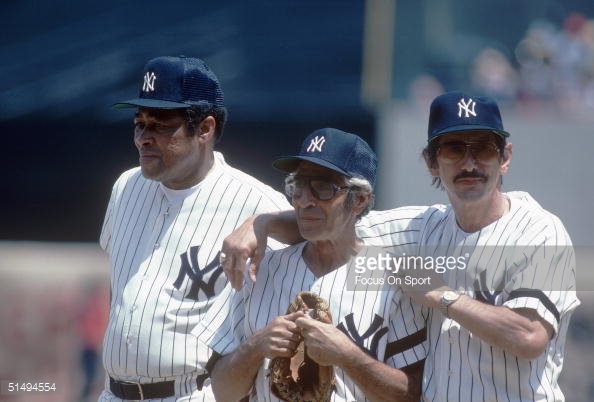 Checking bowling balls, Yogi Berra, left, and Phil Rizzuto work at